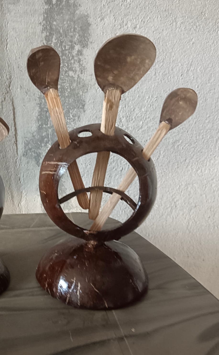 Beautifully handcrafted coconut shell cutlery stand with natural wooden spoons and forks. Eco-friendly, plastic-free, and perfect for kitchen organization or table décor.